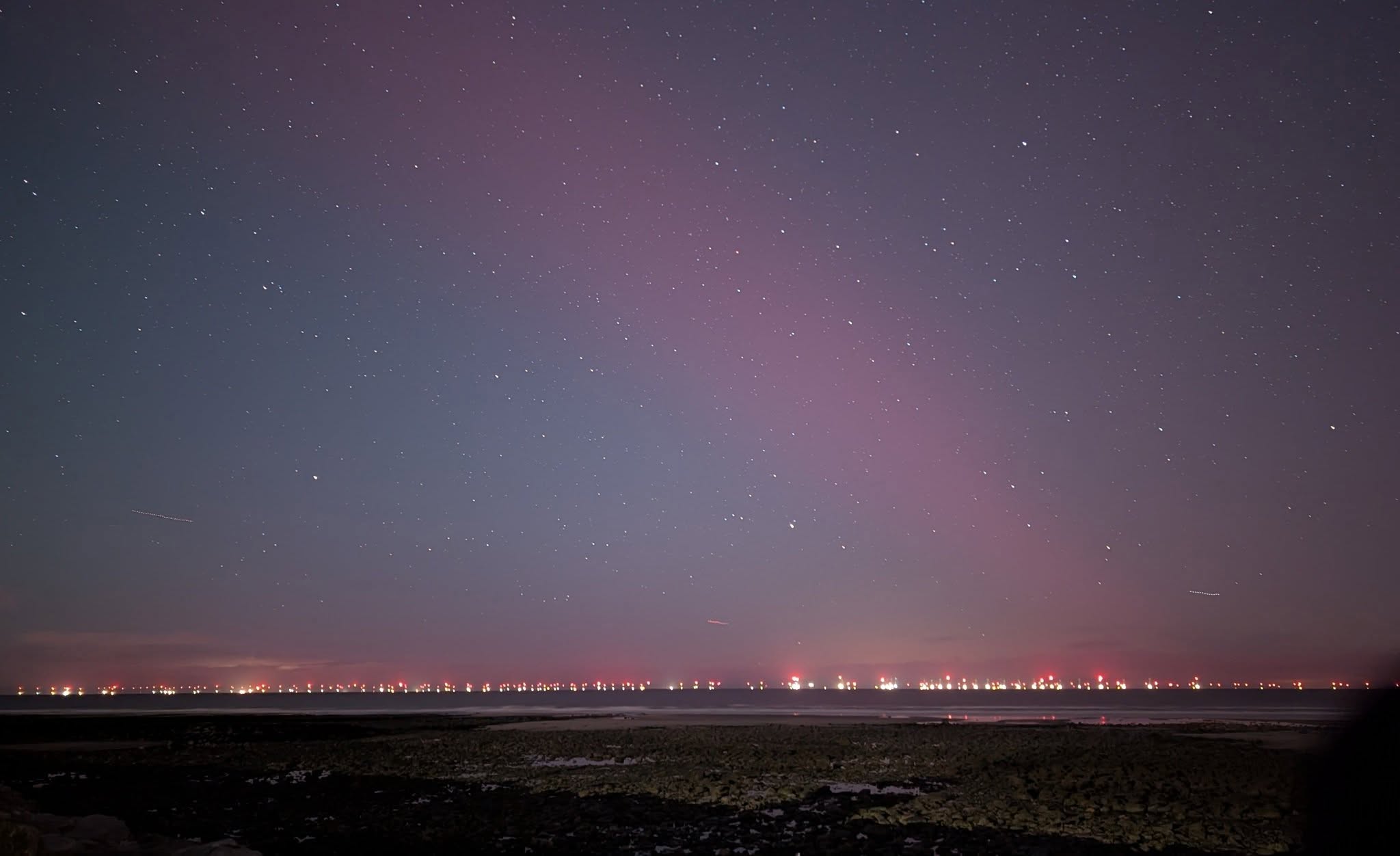 Visualisation of the night sky off the coast lit by turbine aviation warning lights